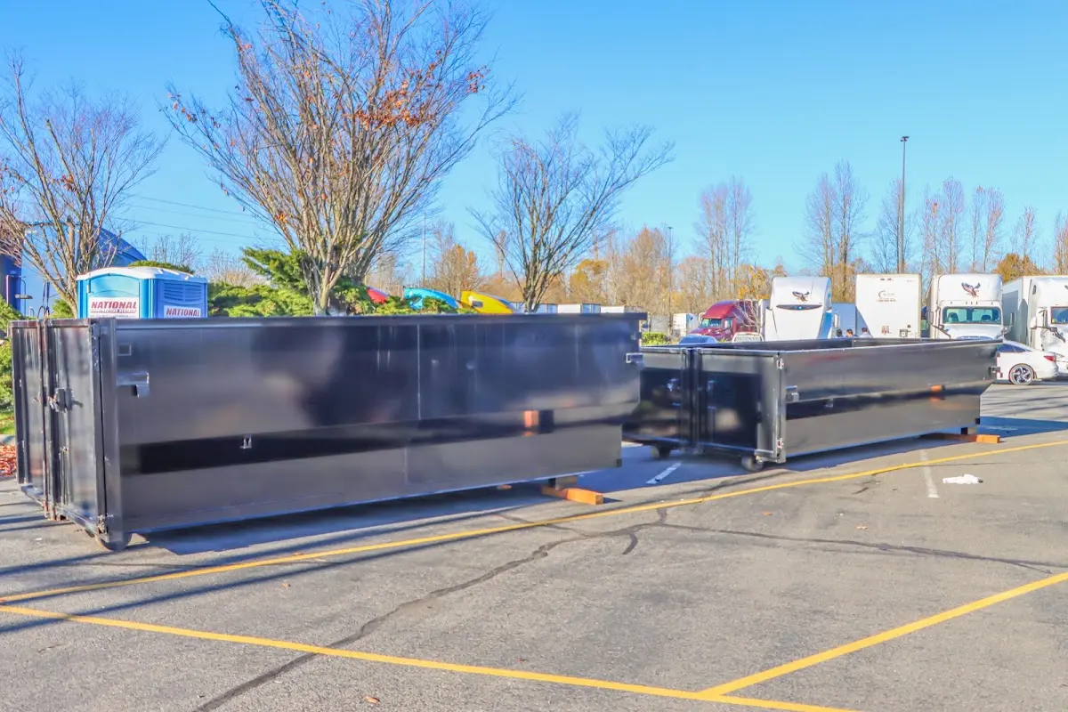 Professional dumpster rental service with roll-off container on residential driveway in Denison